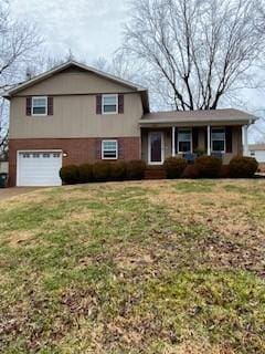 split level home featuring a garage and a front yard