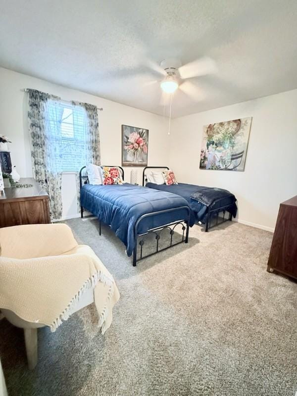 carpeted bedroom with a textured ceiling and ceiling fan