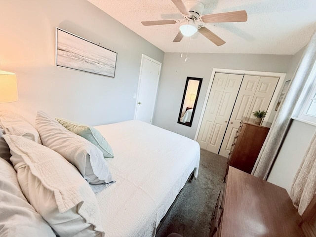 carpeted bedroom featuring ceiling fan, a closet, and a textured ceiling