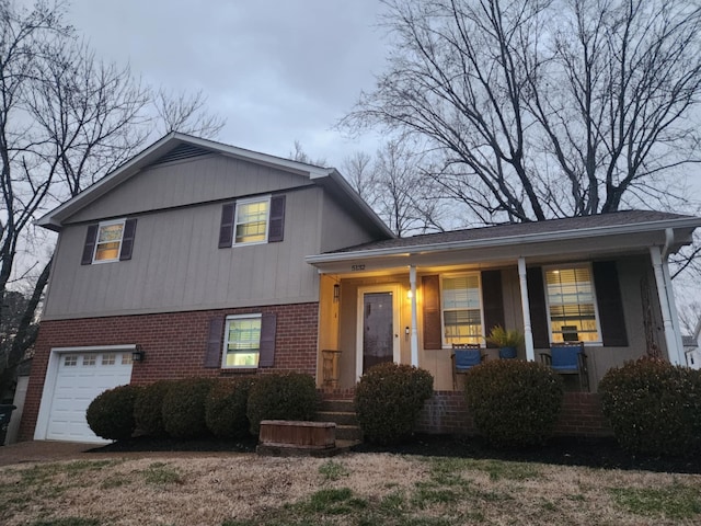 tri-level home with a porch and a garage