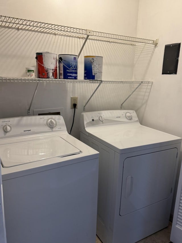 clothes washing area with washer and dryer and electric panel