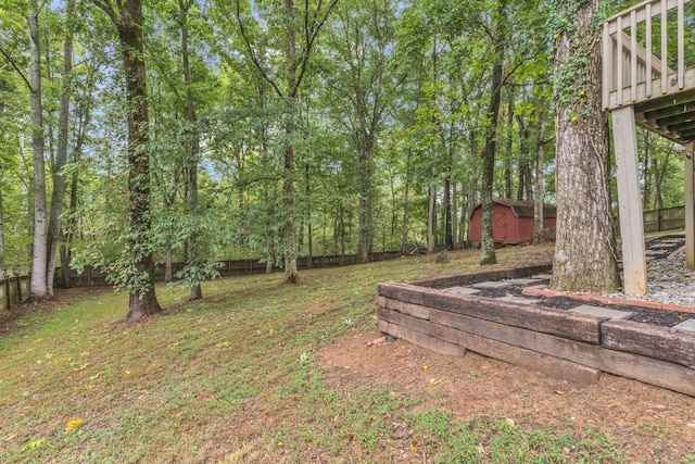 view of yard featuring a shed and a wooden deck