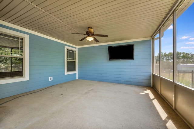 unfurnished sunroom featuring ceiling fan