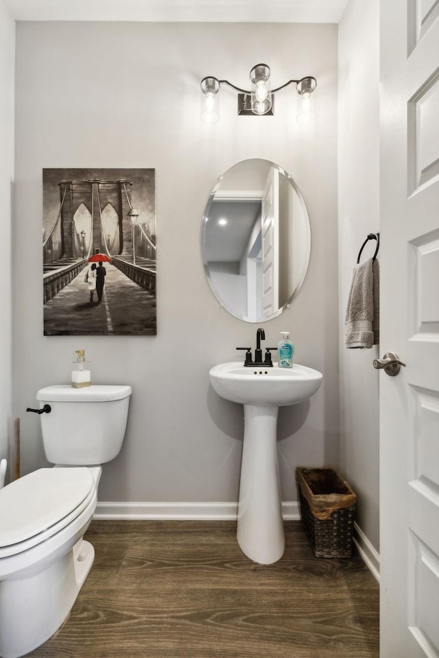 bathroom featuring wood-type flooring and toilet