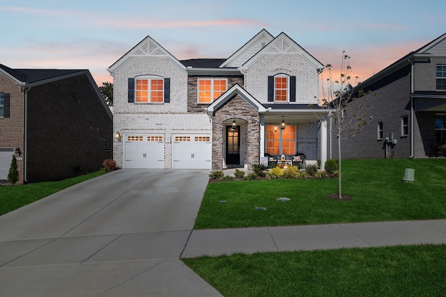 view of front of home with a garage, a porch, and a yard