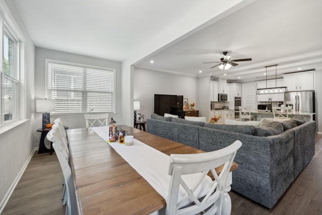 dining space with dark wood-type flooring and ceiling fan