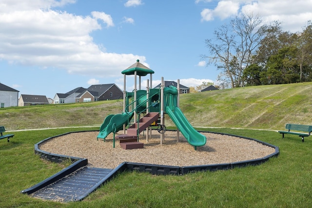 view of jungle gym featuring a lawn