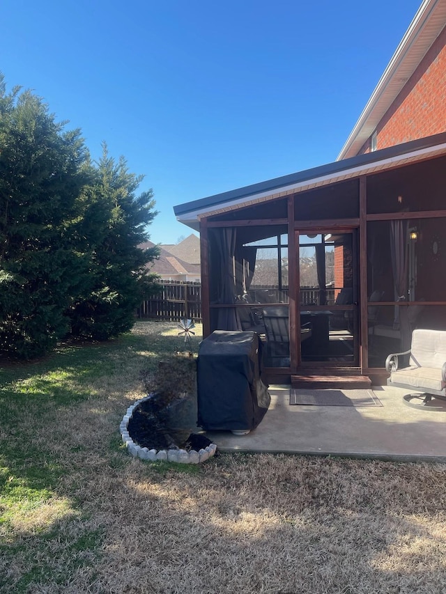 view of yard with a sunroom and a patio area