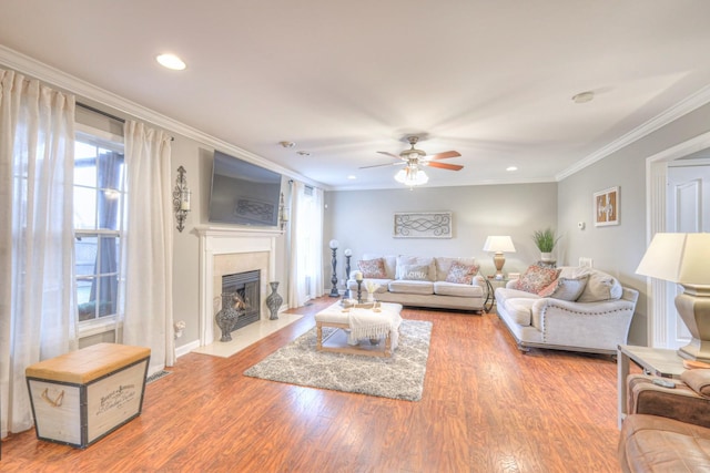 living room featuring crown molding, ceiling fan, and wood-type flooring