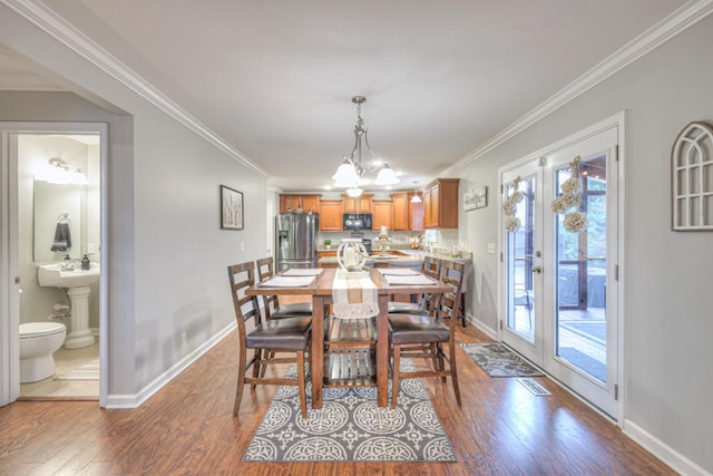 dining area with crown molding and wood-type flooring