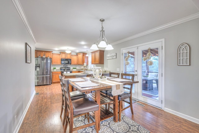 dining area featuring ornamental molding and light wood-type flooring