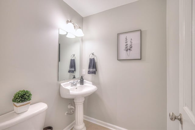 bathroom featuring toilet and tile patterned flooring