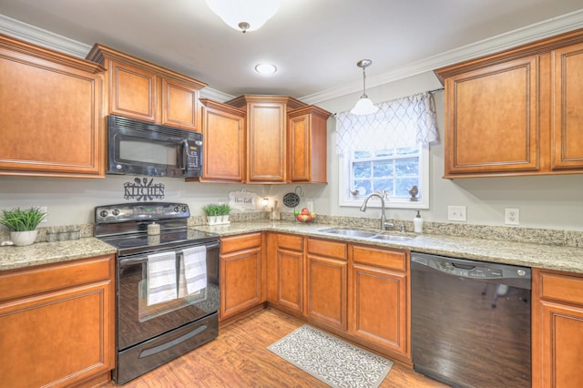 kitchen featuring sink, ornamental molding, black appliances, light stone countertops, and light wood-type flooring