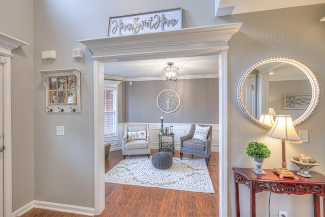 sitting room featuring hardwood / wood-style flooring and ornamental molding