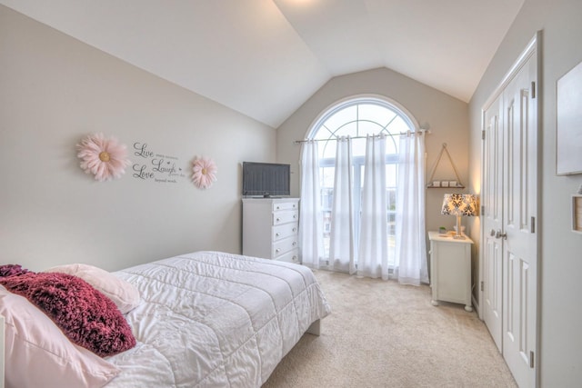 carpeted bedroom with lofted ceiling