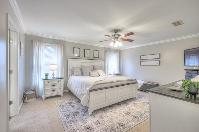 bedroom featuring light colored carpet, ornamental molding, and ceiling fan