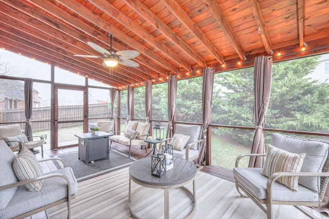 sunroom / solarium featuring vaulted ceiling with beams, a wealth of natural light, wooden ceiling, and ceiling fan