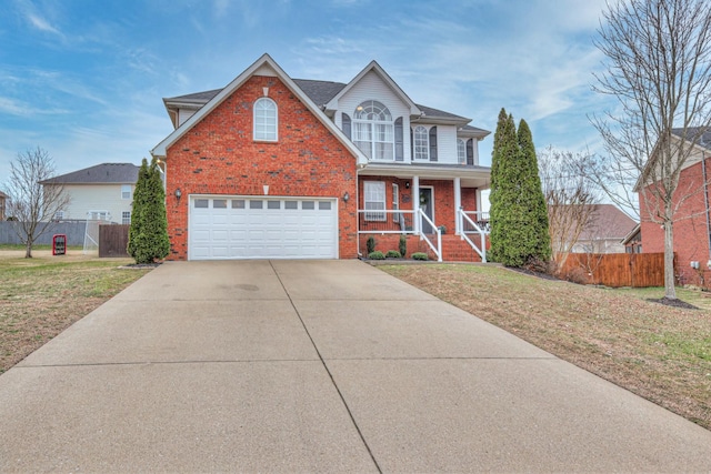 view of front of house featuring a garage, a porch, and a front lawn