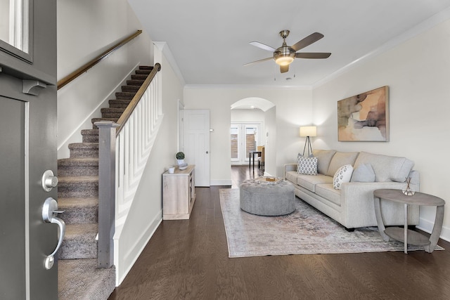 living room featuring dark wood-type flooring, ceiling fan, and ornamental molding