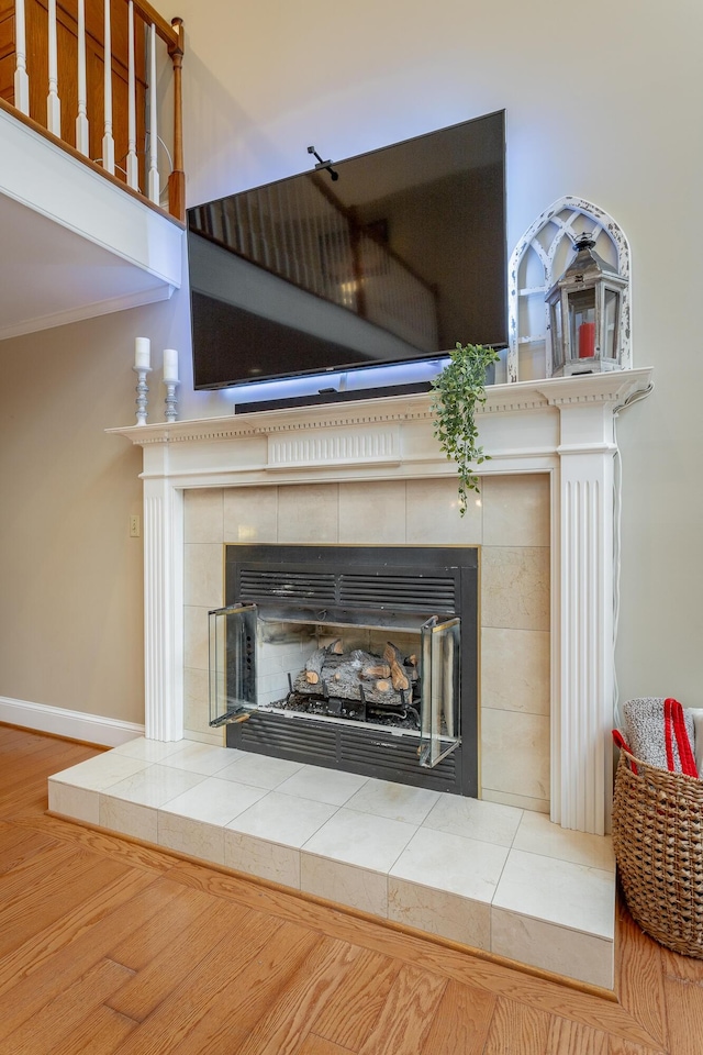 details with crown molding, a fireplace, and hardwood / wood-style floors