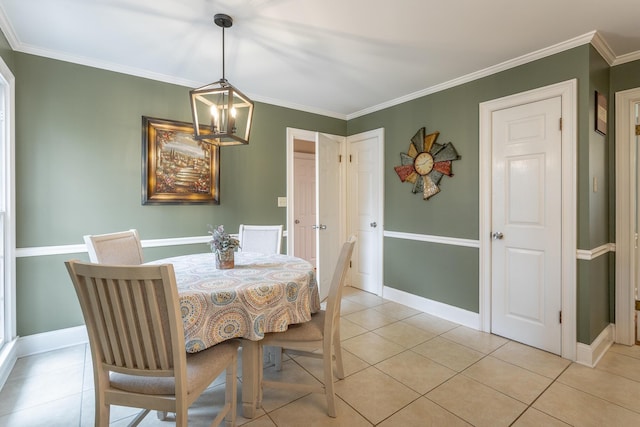 dining space with crown molding, an inviting chandelier, and light tile patterned floors