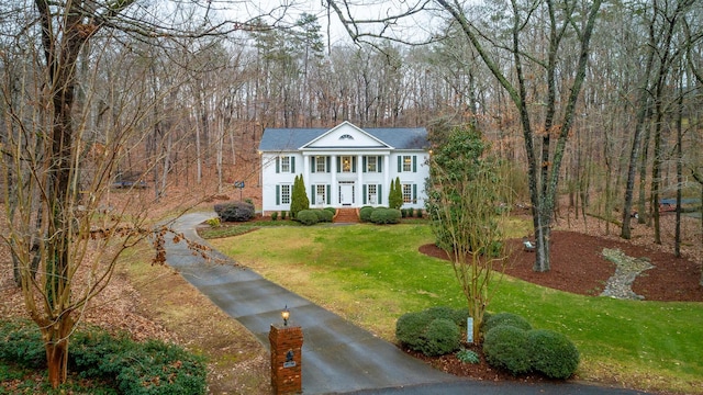 greek revival house with a front lawn