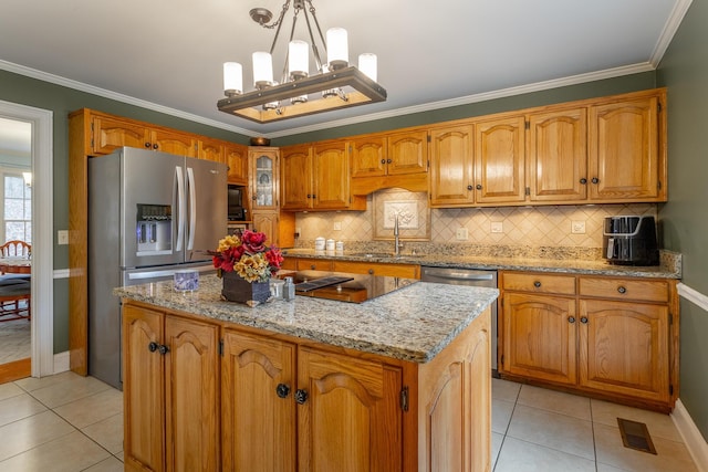 kitchen with appliances with stainless steel finishes, sink, hanging light fixtures, a center island, and crown molding