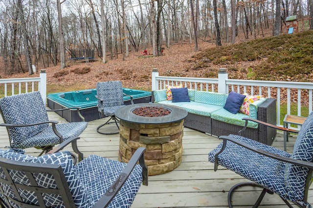 wooden terrace featuring an outdoor living space with a fire pit and a hot tub