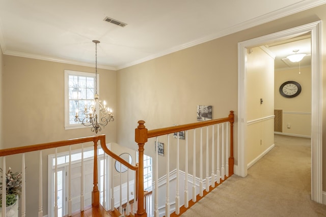 corridor with light colored carpet, ornamental molding, and a chandelier