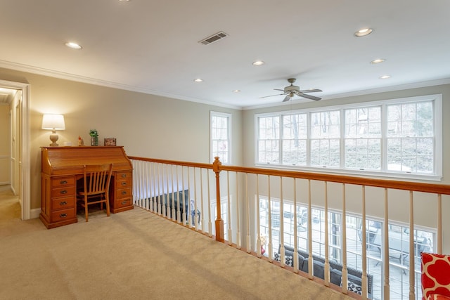 hallway featuring crown molding and light colored carpet