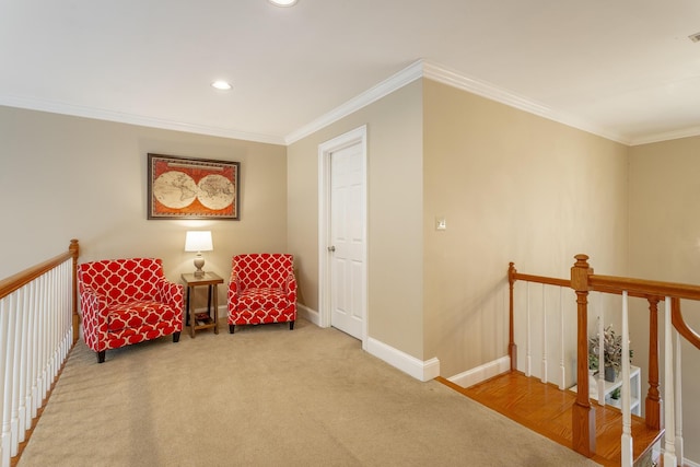 living area with ornamental molding and carpet