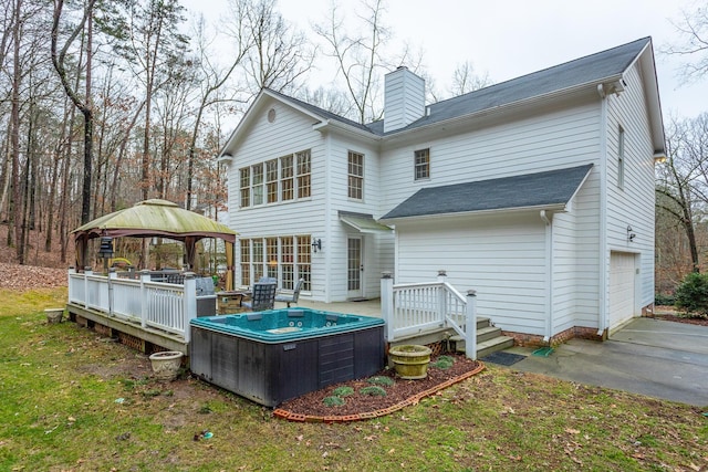 rear view of property with a gazebo and a deck