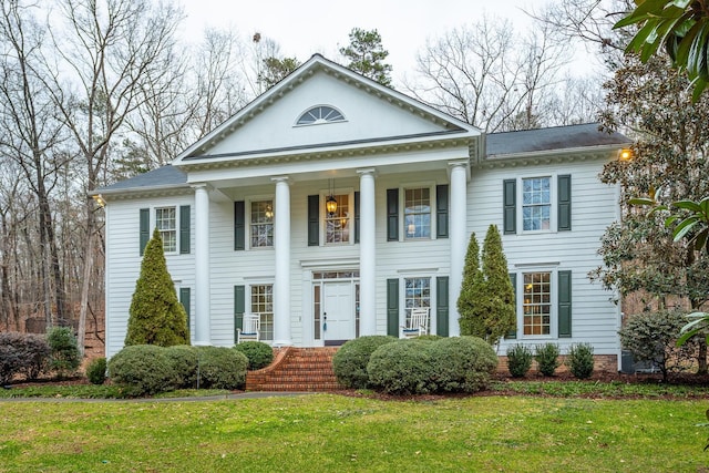 greek revival inspired property featuring a front yard