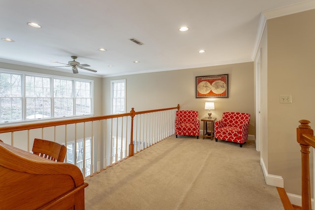 living area with ornamental molding and light carpet