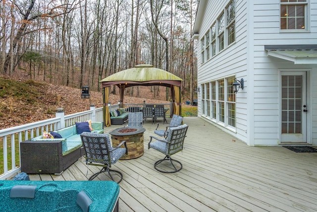 wooden deck with a gazebo and an outdoor living space with a fire pit