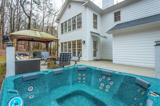 view of pool with an outdoor living space, a gazebo, and a wooden deck