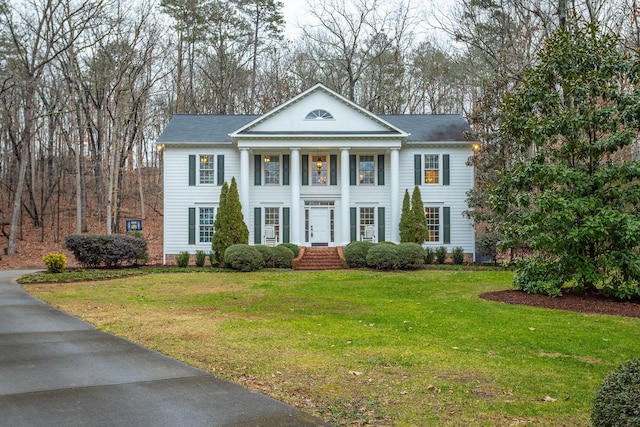 greek revival inspired property with a front yard