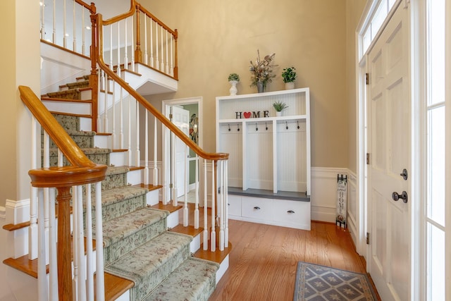 mudroom featuring light hardwood / wood-style floors and a high ceiling