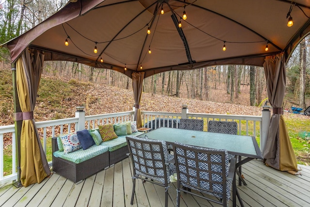 wooden deck featuring an outdoor living space and a gazebo