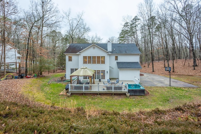 rear view of property with a deck and a lawn