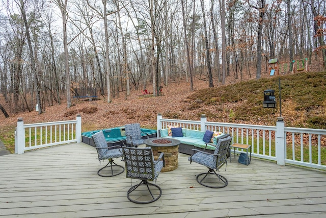 wooden deck with an outdoor living space with a fire pit