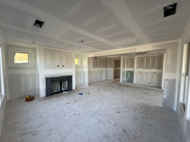 unfurnished living room with a tile fireplace