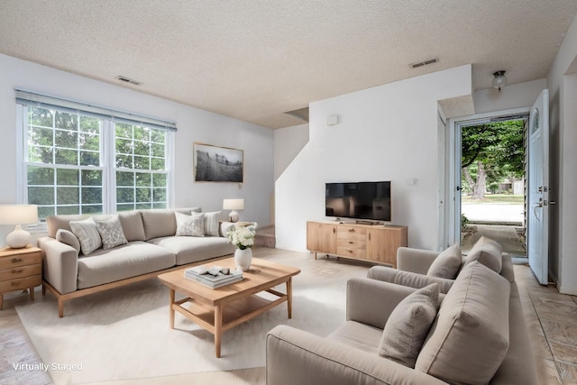 living room with a textured ceiling