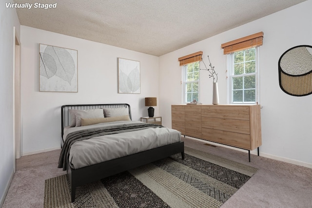 bedroom with carpet and a textured ceiling