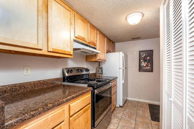 kitchen with light brown cabinetry, stainless steel range with electric cooktop, a textured ceiling, white fridge, and dark stone counters