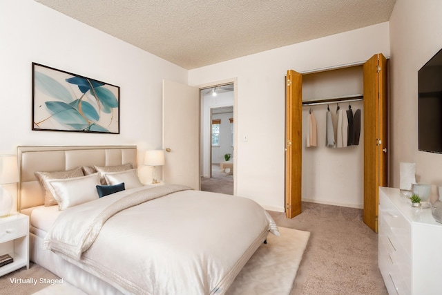 carpeted bedroom featuring a closet and a textured ceiling