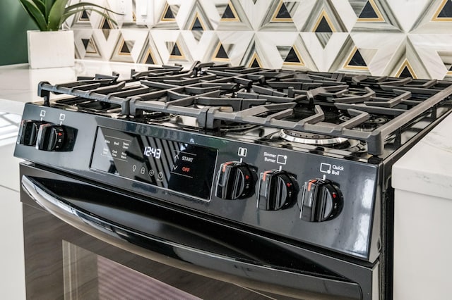 details with tasteful backsplash and black gas stove