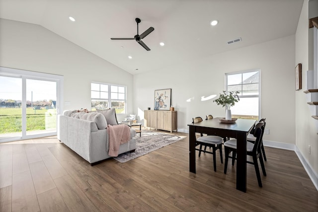 dining room featuring dark wood-type flooring, ceiling fan, and high vaulted ceiling