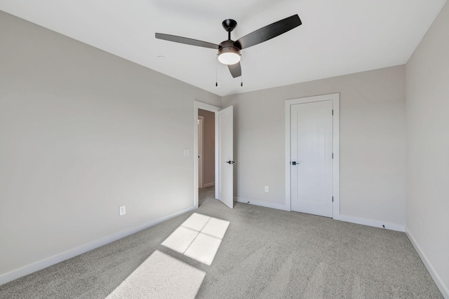 unfurnished bedroom with light colored carpet and ceiling fan