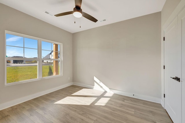 empty room with light hardwood / wood-style flooring and ceiling fan